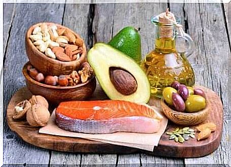 Healthy foods, nuts, salmon, avocado and olives