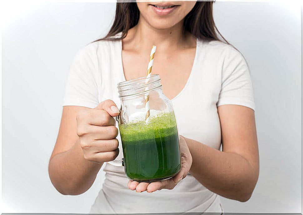 Young lady with cucumber juice