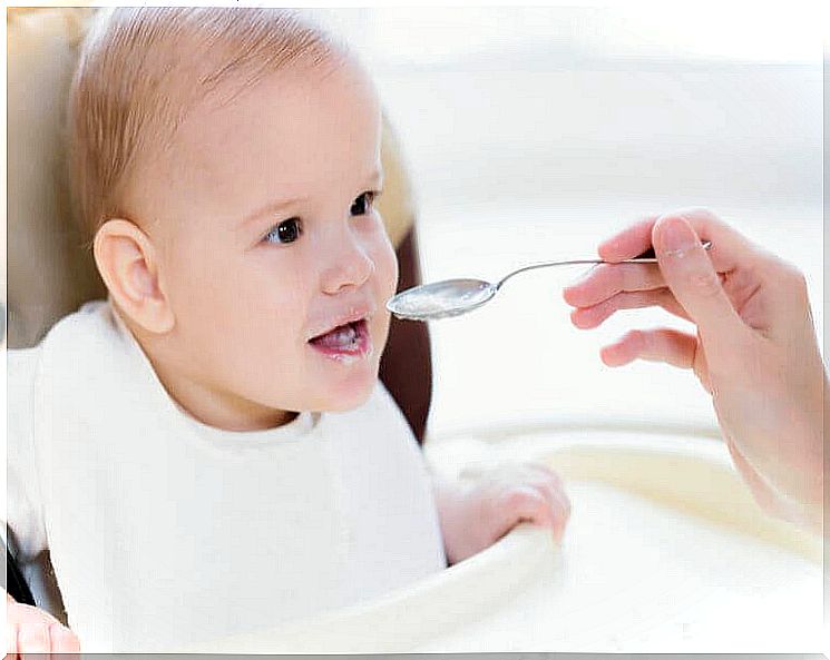 Baby gets a bite from a spoon