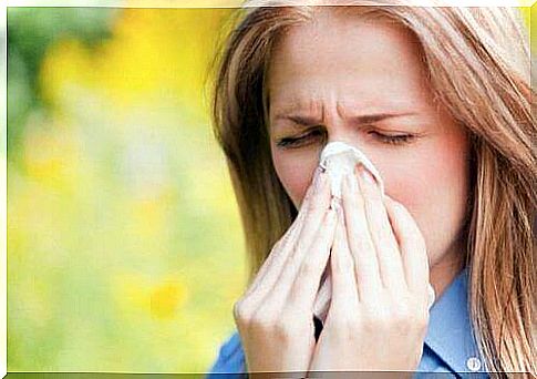 Blonde woman blows nose into handkerchief