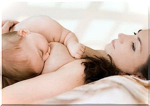 Mother breastfeeds baby