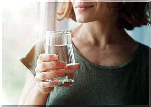 Woman drinks a glass of water